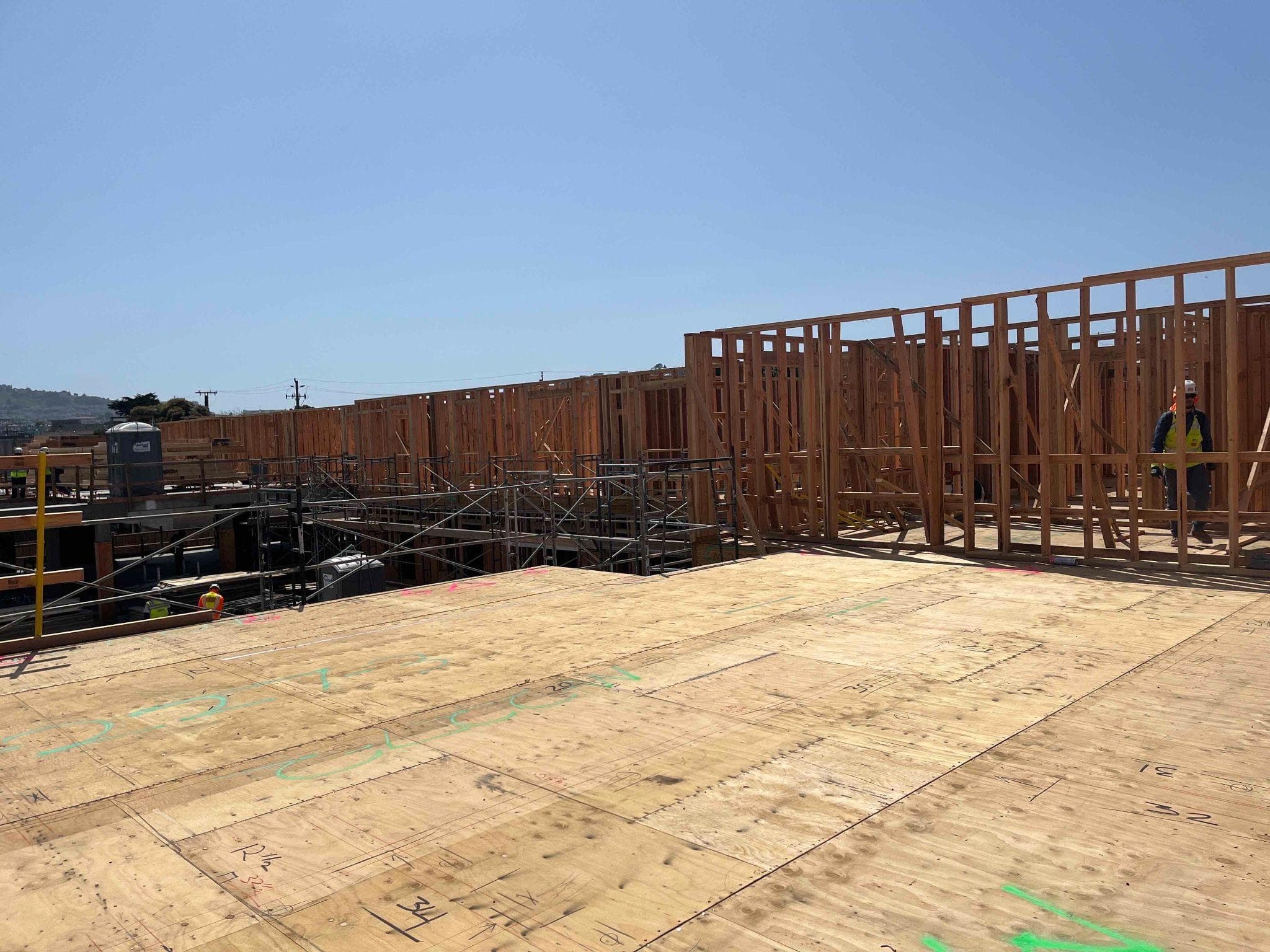Multi-story framing progress with floor and wall panels