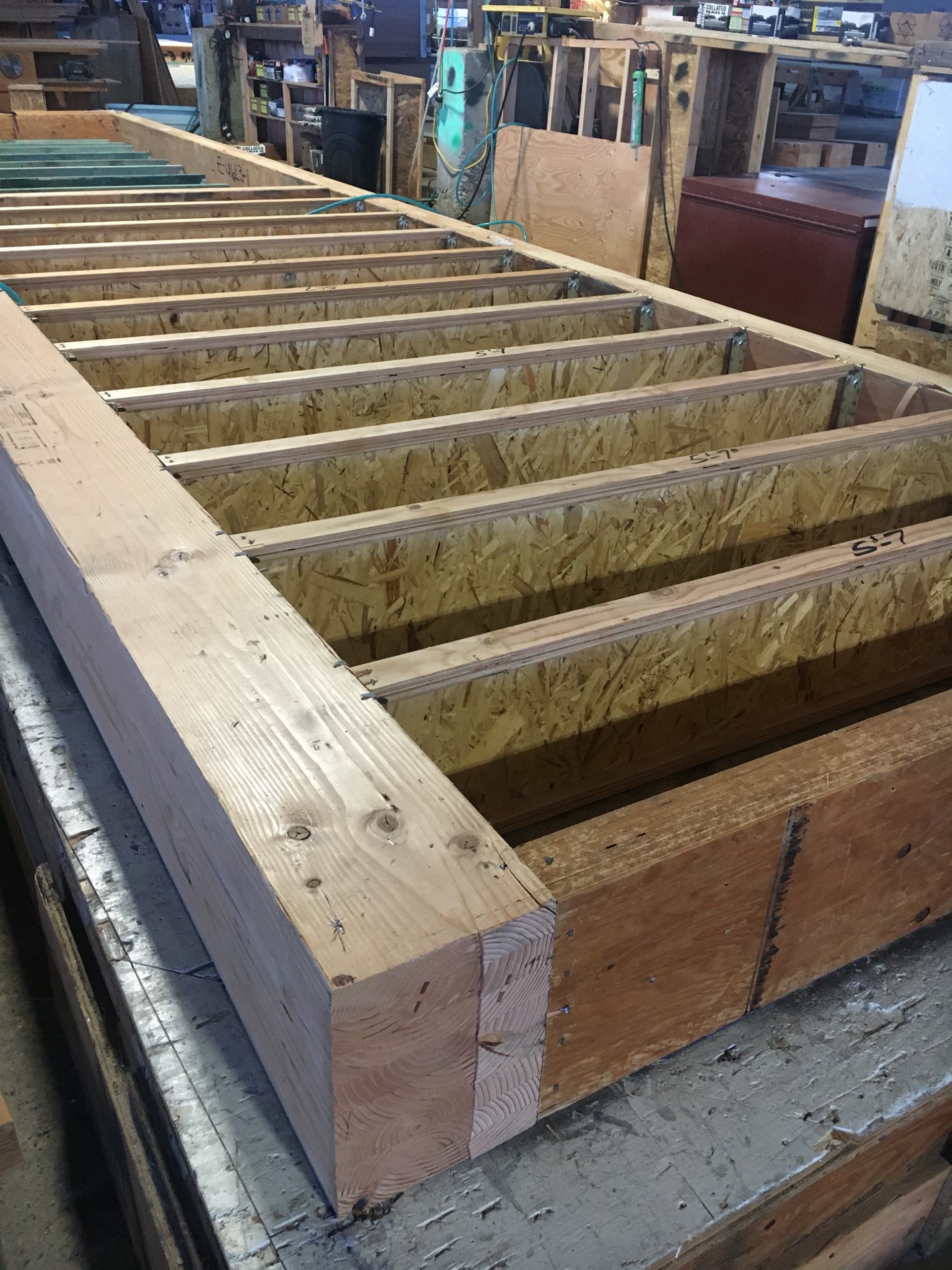 NCC floor cassette on factory assembly table showing precision joist layout