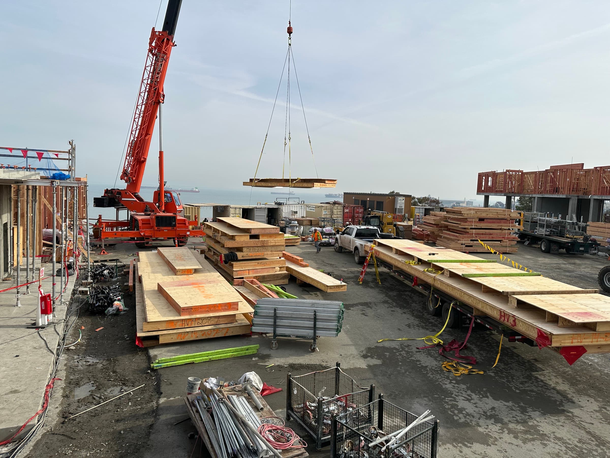 NCC crane lifting floor cassette with San Francisco Bay in background at Hunters View