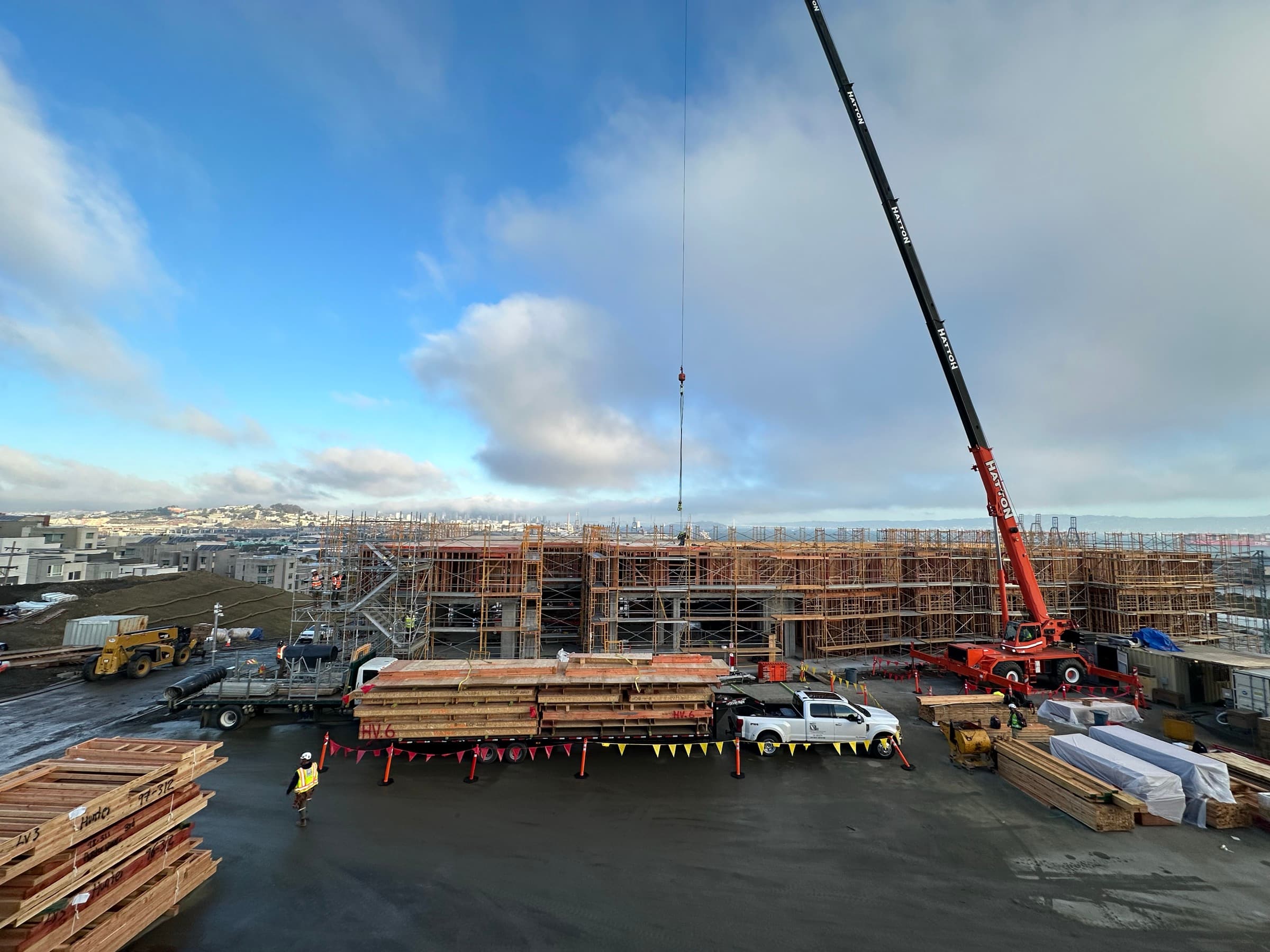 Hunters View construction site with crane and stacked NCC panels
